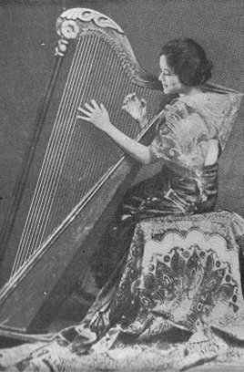 Vintage black-and-white photograph of a Filipina woman playing a harp